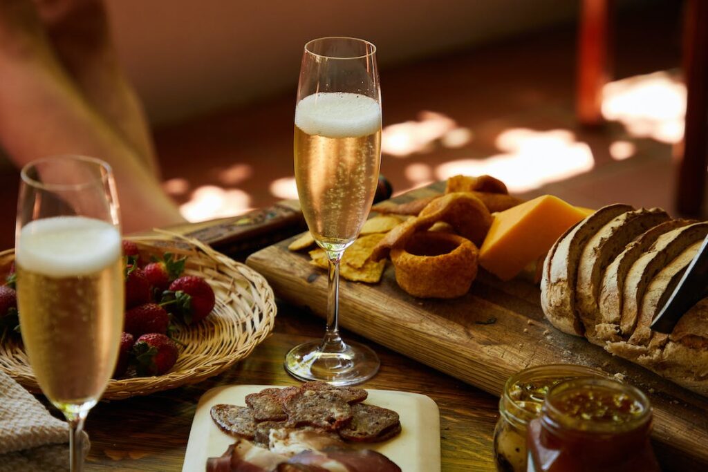 glass of prodolce on a table with food