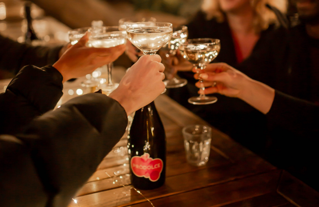 people drinking prodolce at dinner party