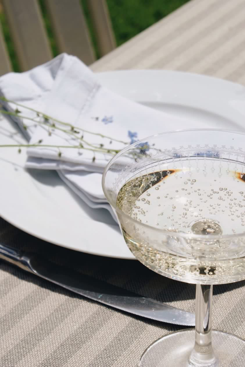 glass of sparkling wine next to a plate